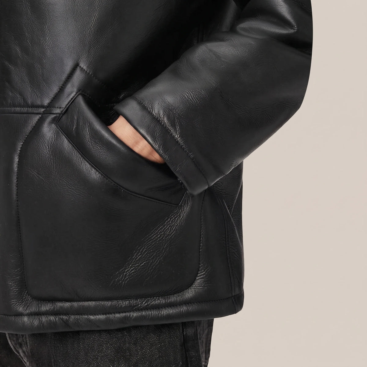 Real shearling wool lining inside black leather coat