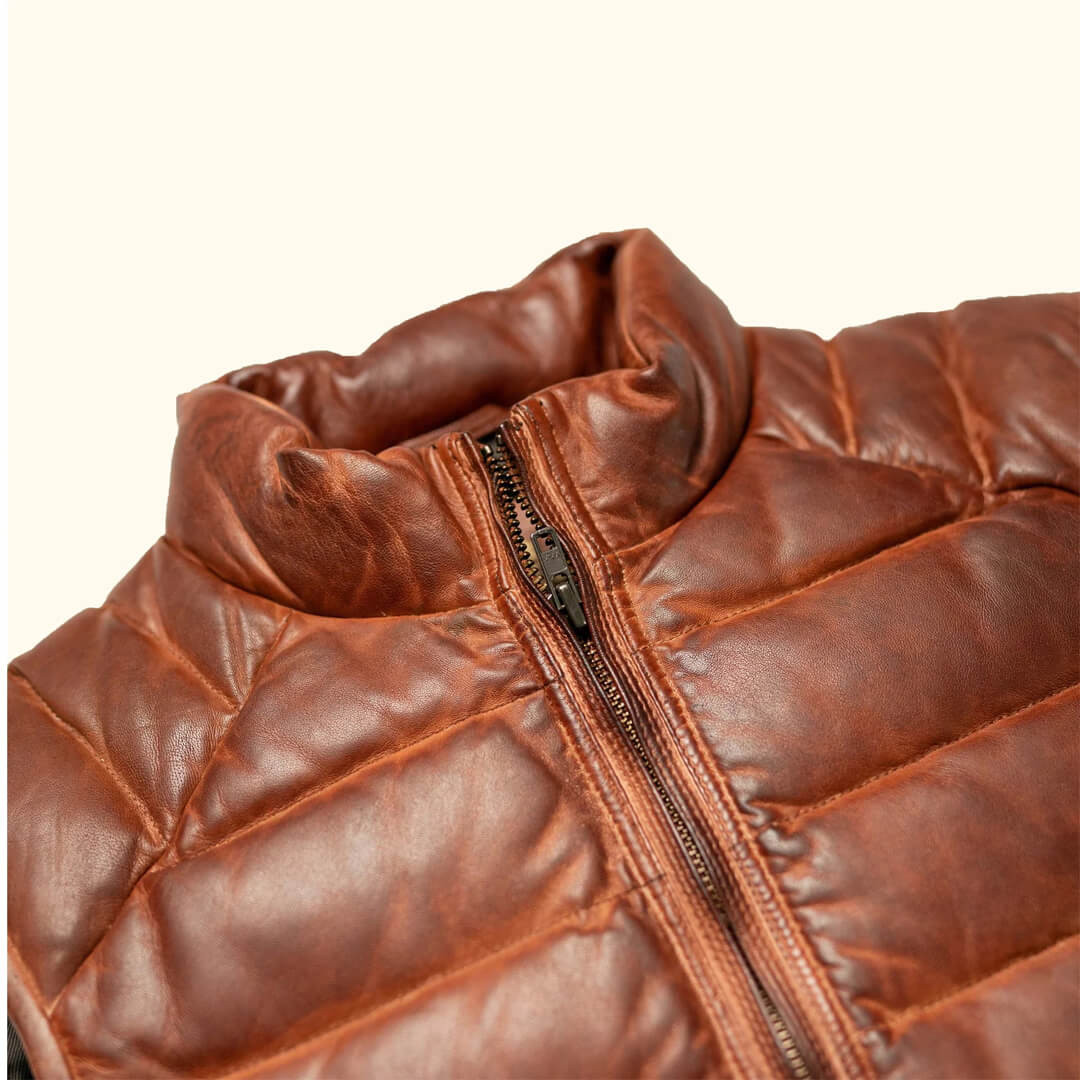 Light brown Nollaige cozy puffer vest, sleeveless and warm, ideal for stylish winter layering.