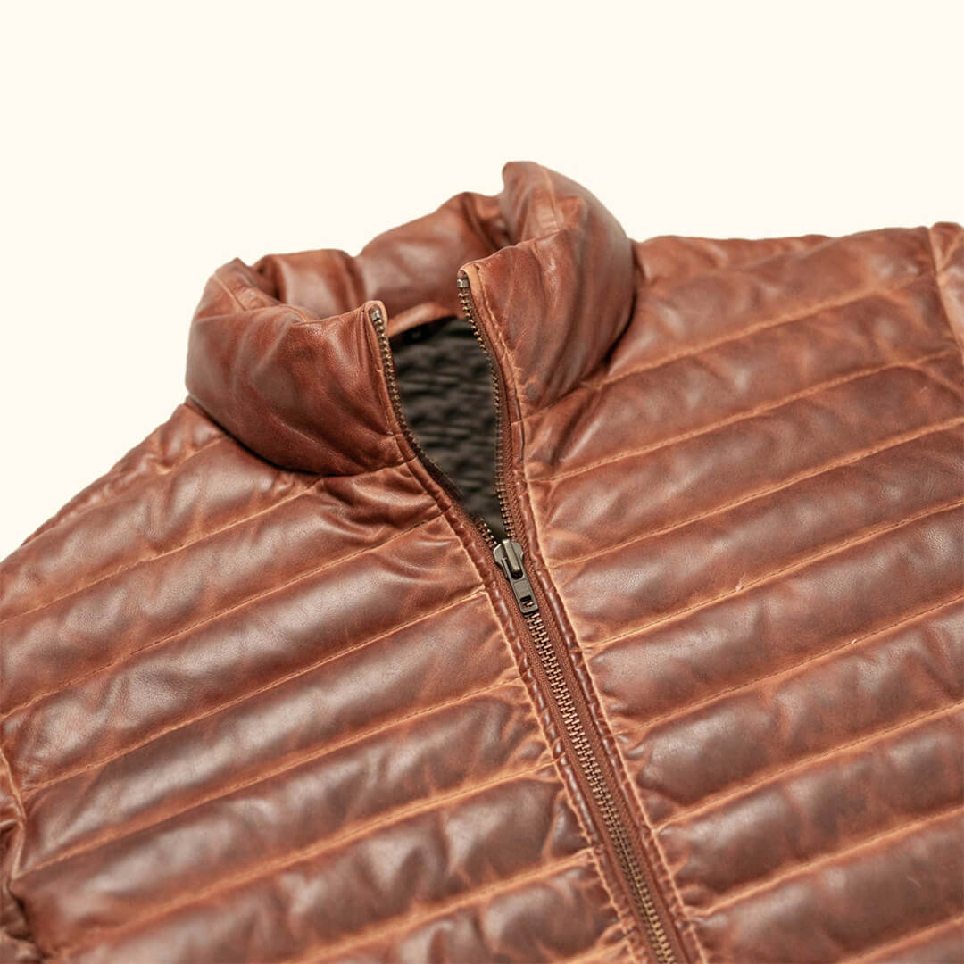 Stylish men's real lambskin leather puffer jacket with a smooth finish and luxurious design on a white background.