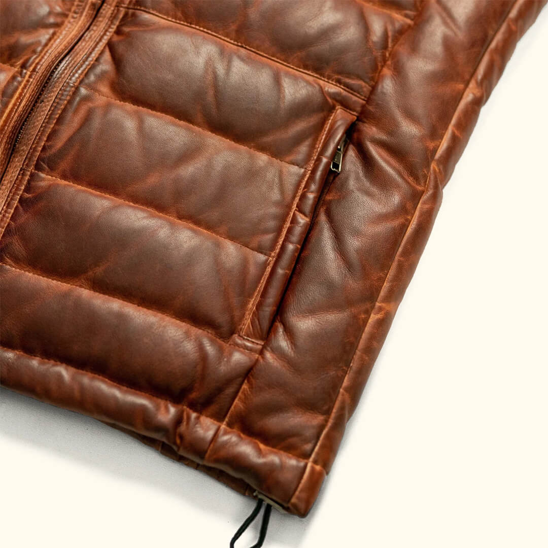 Light brown Nollaige cozy puffer vest, sleeveless and warm, ideal for stylish winter layering.