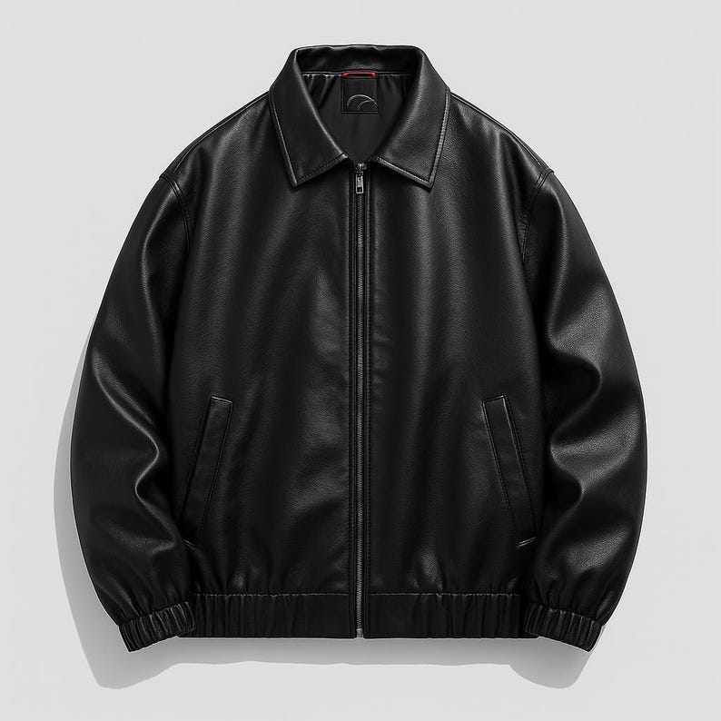 Flat lay of unisex black original leather bomber jacket with zip front – Cowskin Jackets