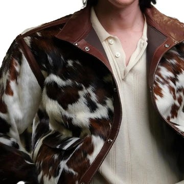 Man wearing a rugged genuine cow skin leather cowboy jacket with classic Western styling, standing confidently outdoors.