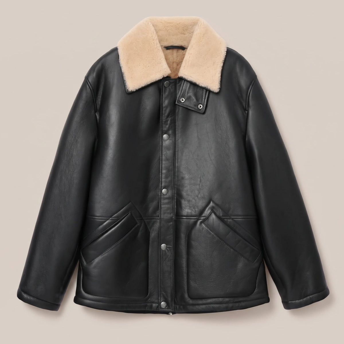 Welt pocket detail on black semi-shine leather coat