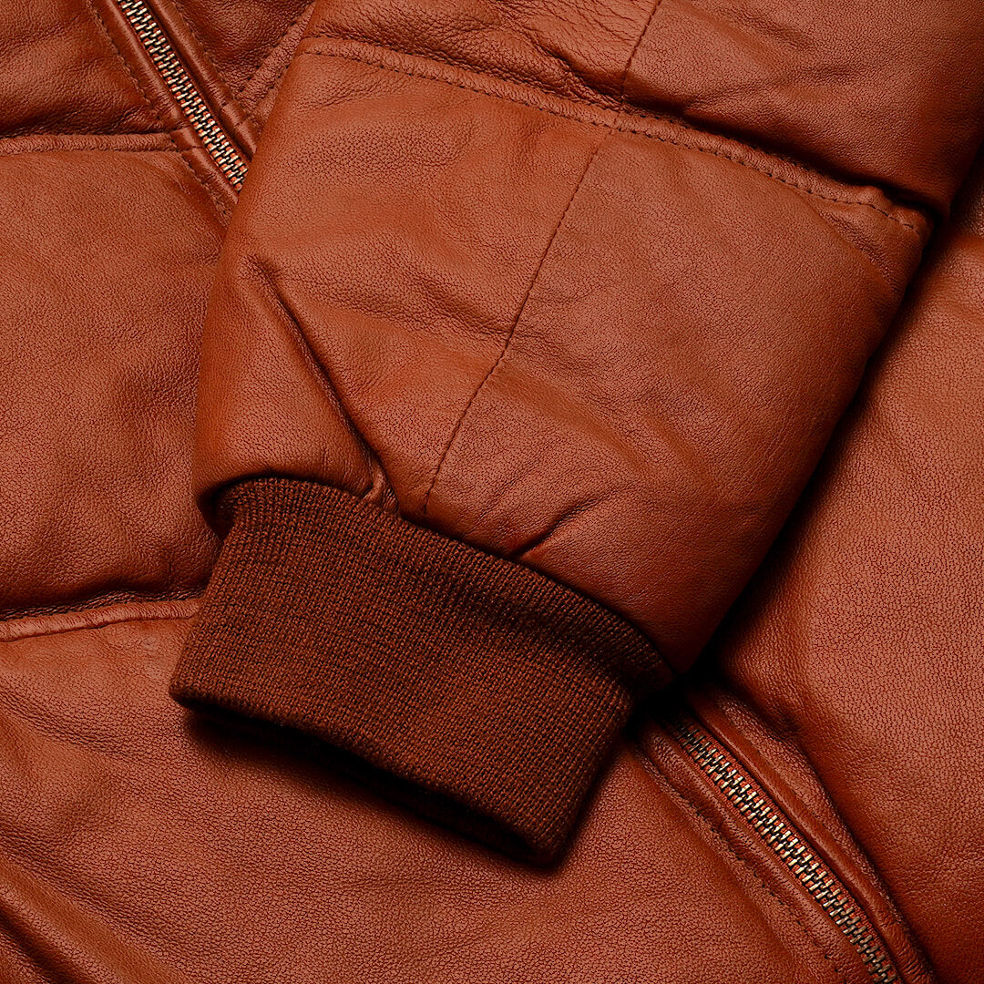 Warm Griffin Puffer Jacket in rich brown color, displayed as essential gear for cold climates, highlighting style and warmth.