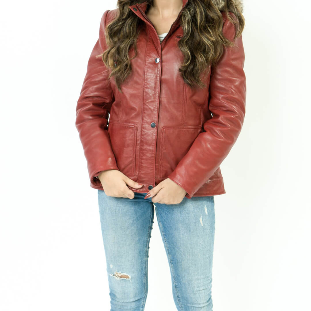 Elegant women's dark pink leather jacket with fur lining and hood, showcasing stylish winter fashion.