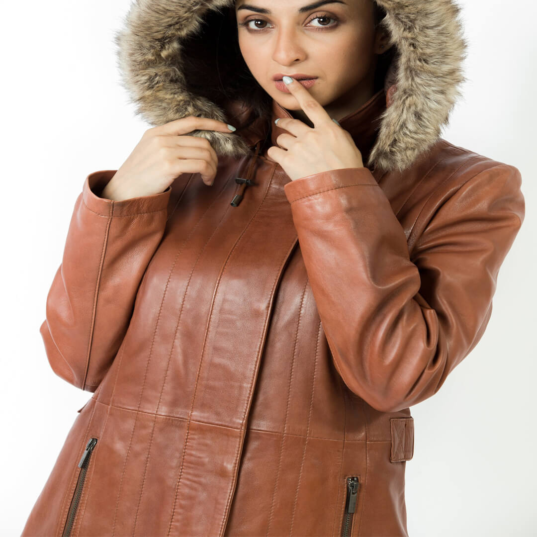 Woman's chic red leather hooded jacket, stylish and long, perfect for winter outerwear fashion.