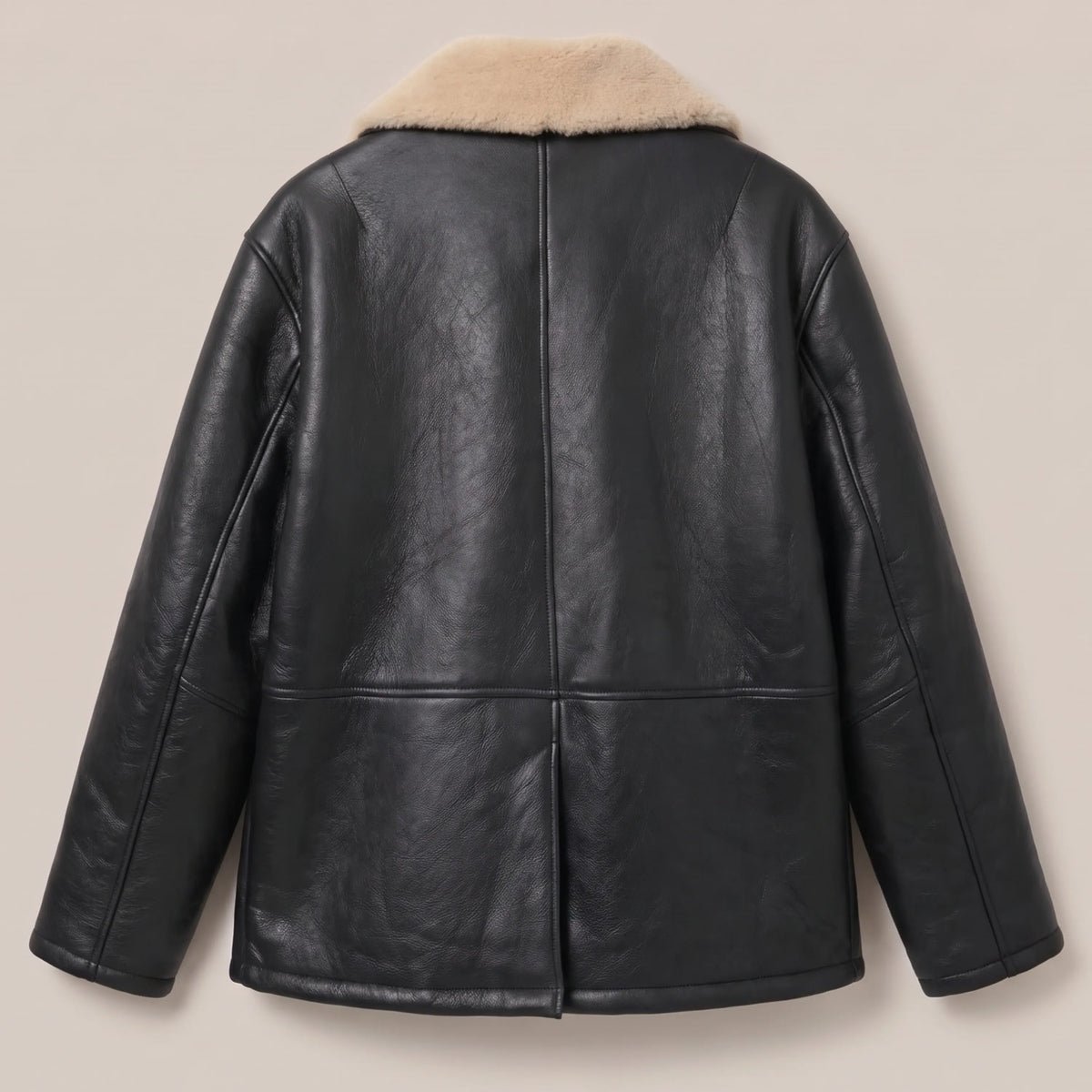 Close-up of sand shearling collar on black leather coat